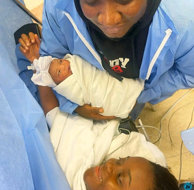 Comedian Ajebo, his wife and their baby